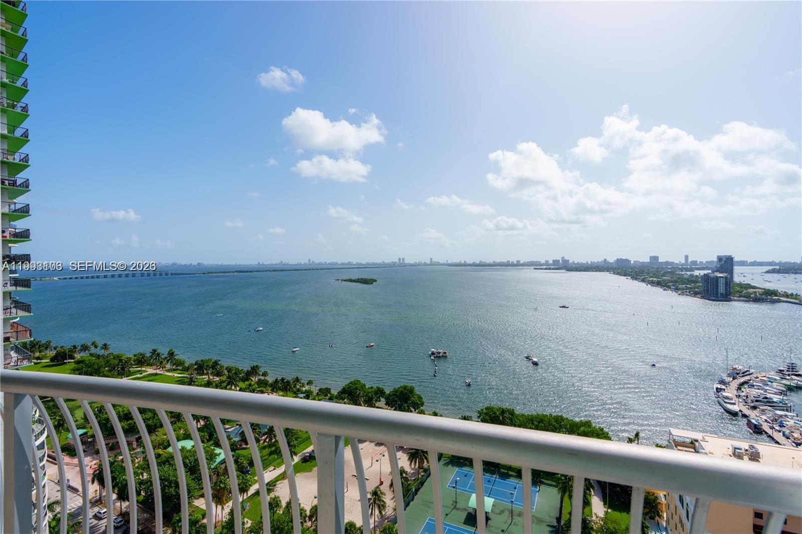 A high-angle view from a balcony overlooks a bay, a park, and a marina — 1750 N Bayshore Dr # 2401, Miami FL 33132, MIAMI, FL