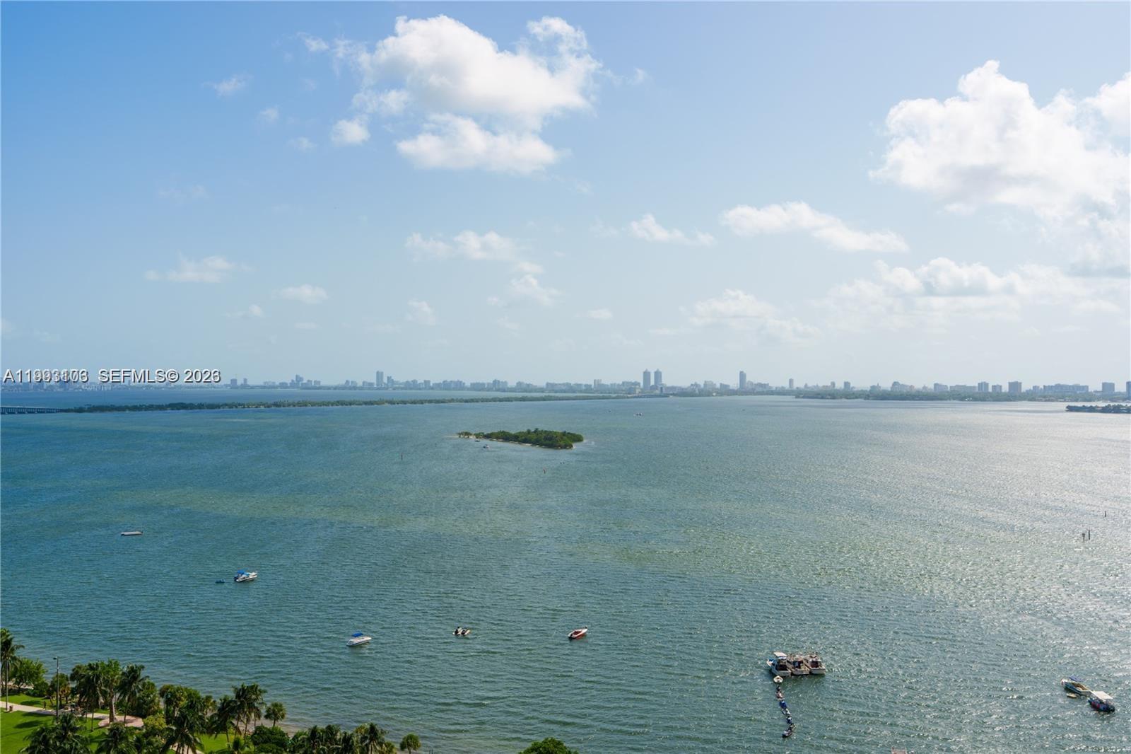 An aerial view shows a body of water with a small island and several boats — 1750 N Bayshore Dr # 2401, Miami FL 33132, MIAMI, FL