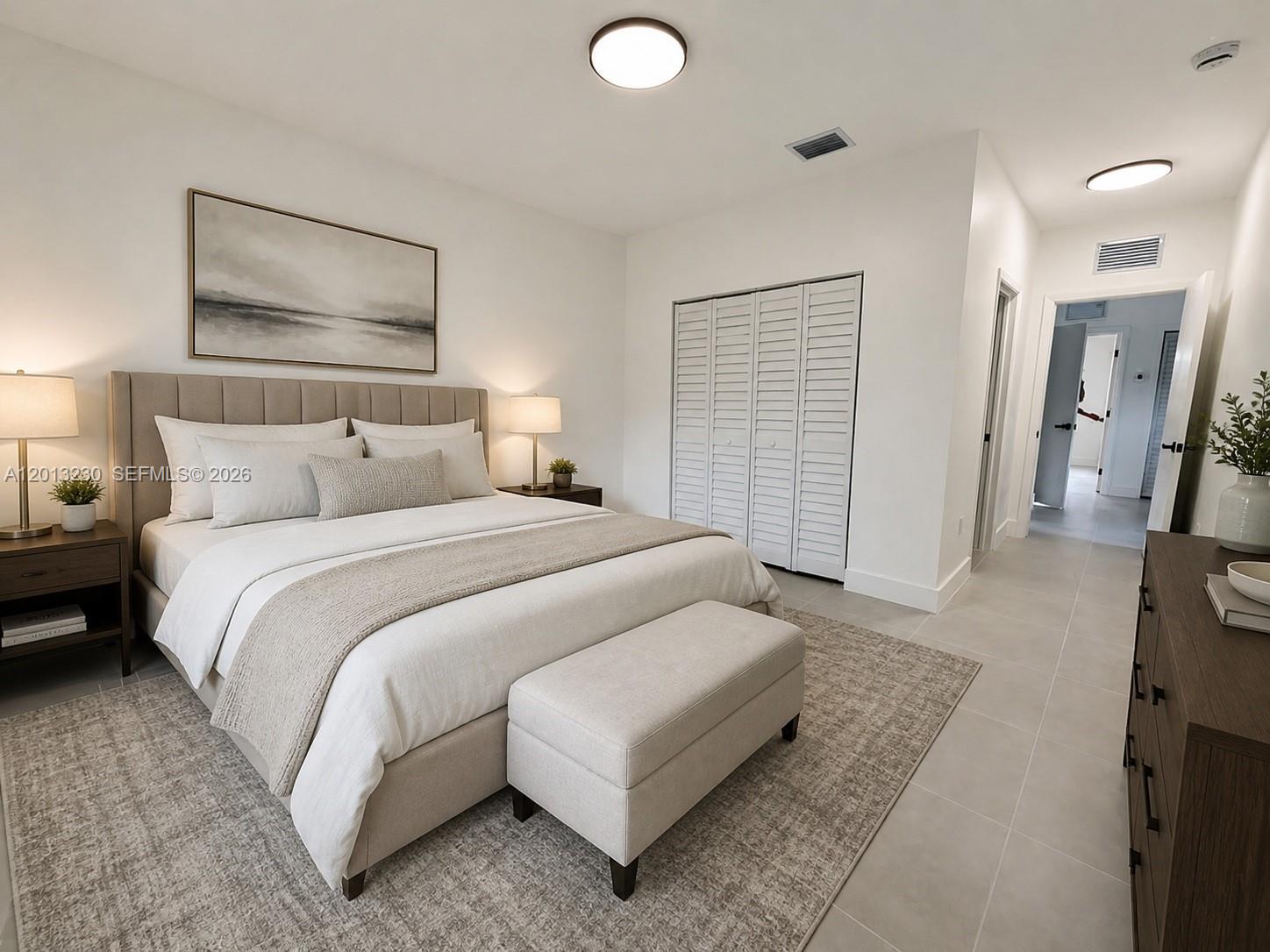 A bedroom features a neutral-toned bed, a bench, a closet, and tiled flooring — 1440 NW 61st St # 2, Miami FL 33142, MIAMI, FL