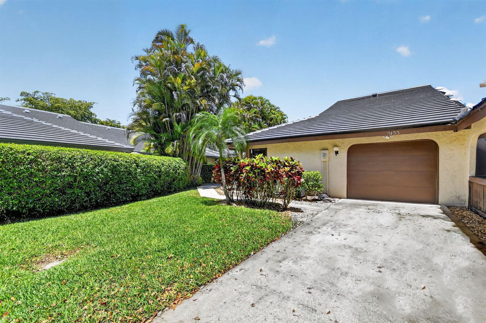 A single-story house with a brown garage door, a concrete driveway, and a manicured lawn — 5155 Pine Drive, Boynton Beach FL 33437, BOYNTON BEACH, FL