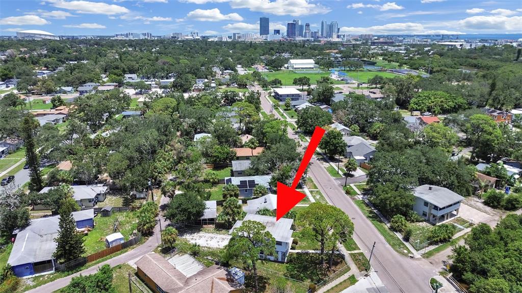 An aerial view shows a two-story house with a red arrow pointing to its roof — 2371 7TH STREET S, ST PETERSBURG, FL