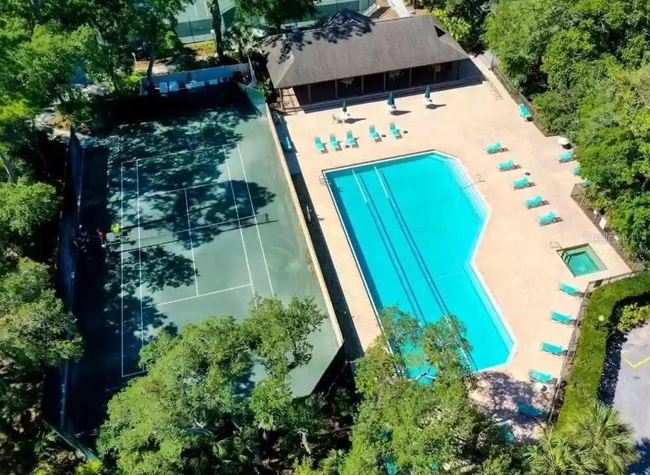 An aerial view shows a tennis court next to a swimming pool and covered pavilion — 3107 HEATHERWOOD LANE, SARASOTA, FL