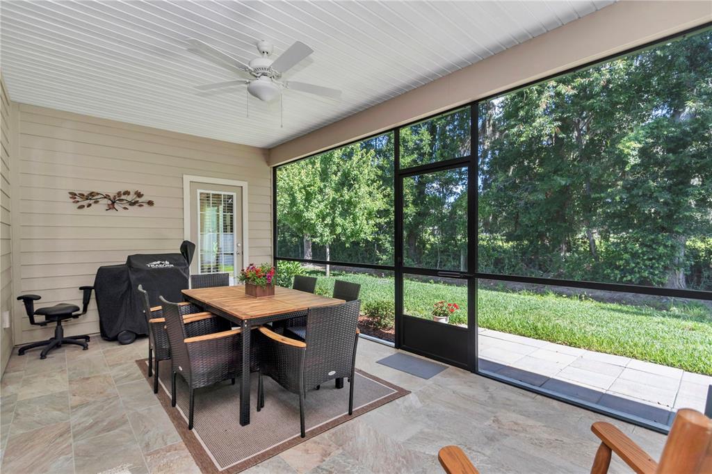 An aerial view of a single-story house with a three-car garage and stone accents — 7663 SW 74TH LOOP, OCALA, FL