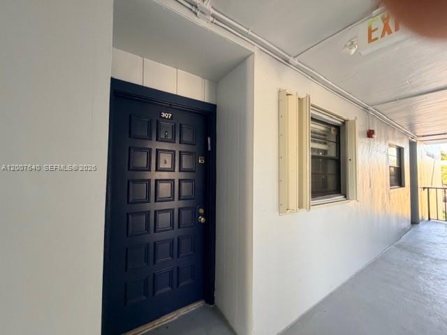 A dark blue door with the number 307 is located in an outdoor apartment hallway — 10825 SW 112th Ave # 307, Miami FL 33176, MIAMI, FL