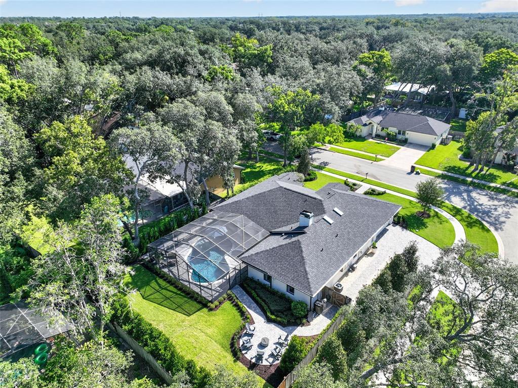 A single-story house with a white brick exterior, a paved walkway, and a manicured lawn — 1054 WHISPERING COVE, CASSELBERRY, FL