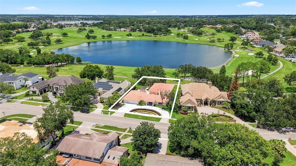 An aerial view shows a single-story house with a red roof bordering a golf course — 5912 TARAWOOD DRIVE, ORLANDO, FL