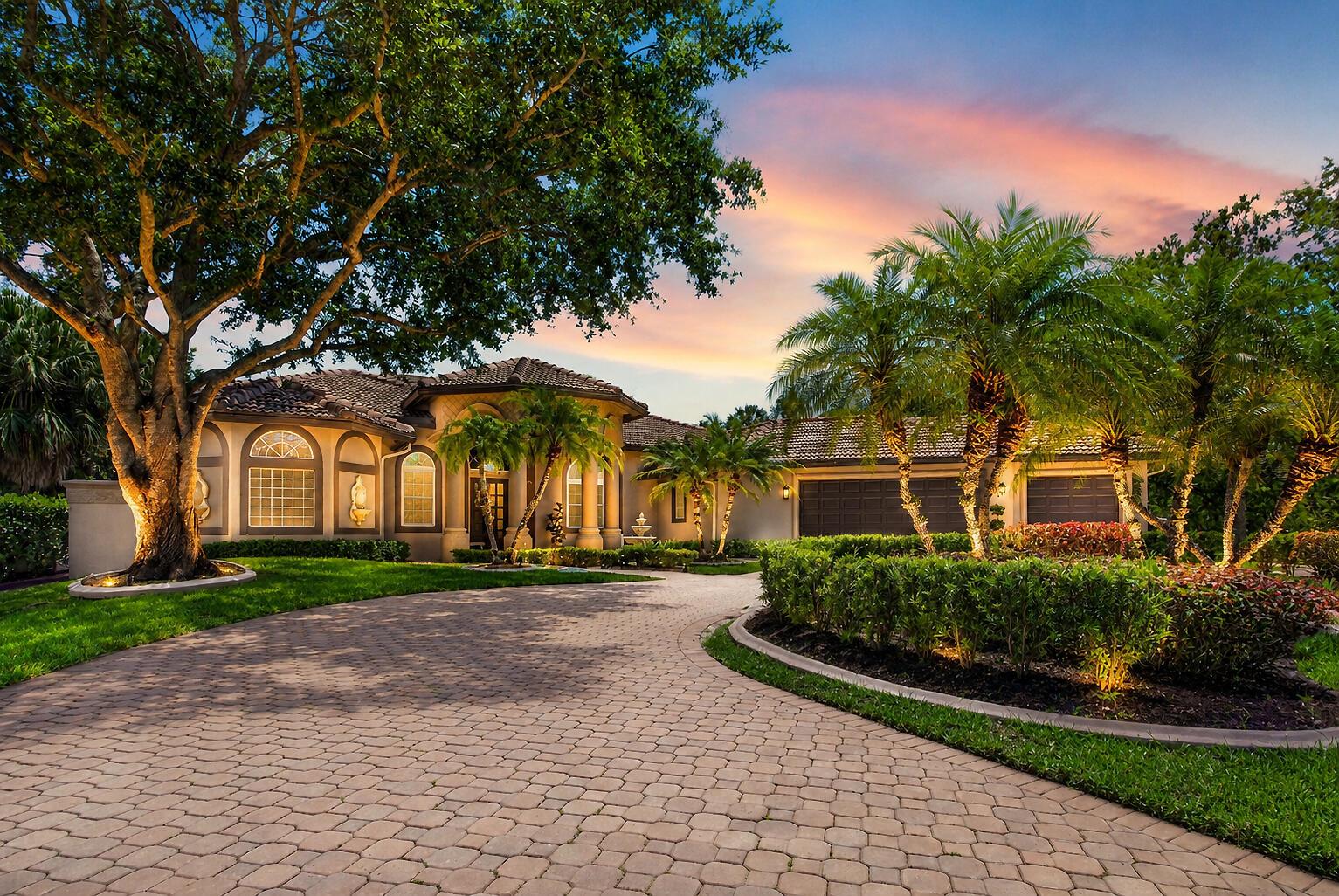 A single-story house with a paved circular driveway, palm trees, and a large oak tree — 5884 NW 79th Way, Parkland FL 33067, PARKLAND, FL