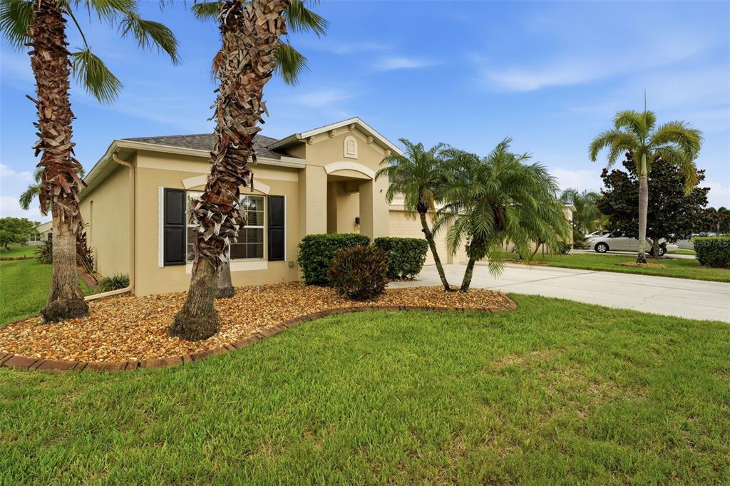 A tiled hallway leads through arched doorways toward a living area with light-colored walls — 8956 39TH STREET CIRCLE E, PARRISH, FL