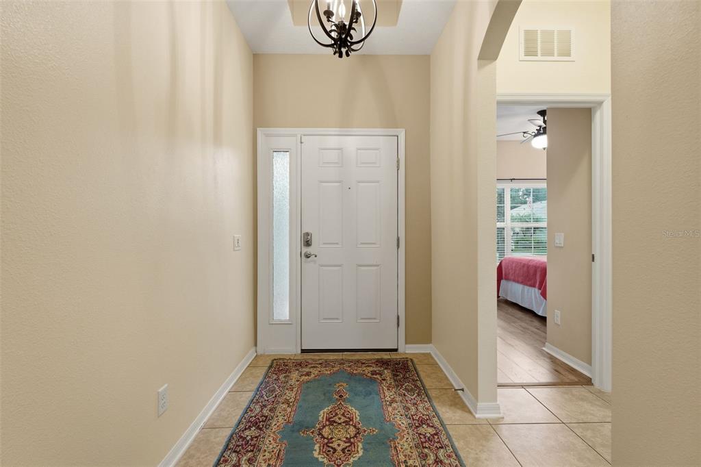 A bathroom features a dark wood vanity with a stone countertop and two wall mirrors — 8956 39TH STREET CIRCLE E, PARRISH, FL