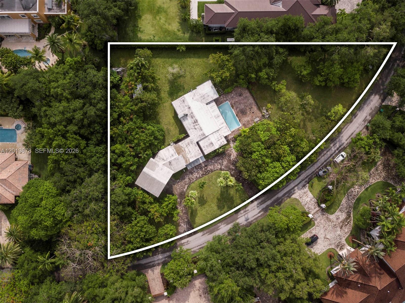 An aerial view shows a house with a pool situated on a triangular lot — 10851 SW 68th Ave, Pinecrest FL 33156, PINECREST, FL
