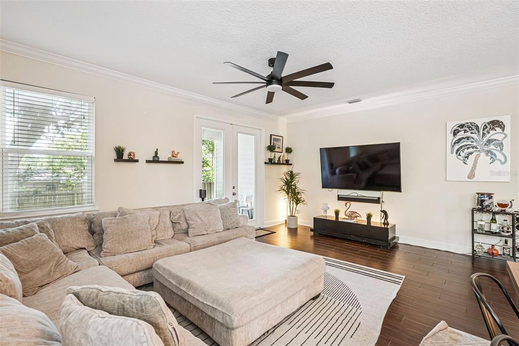A living room features a large sectional sofa, a television, and a ceiling fan — 2508 E CHURCH STREET, ORLANDO, FL