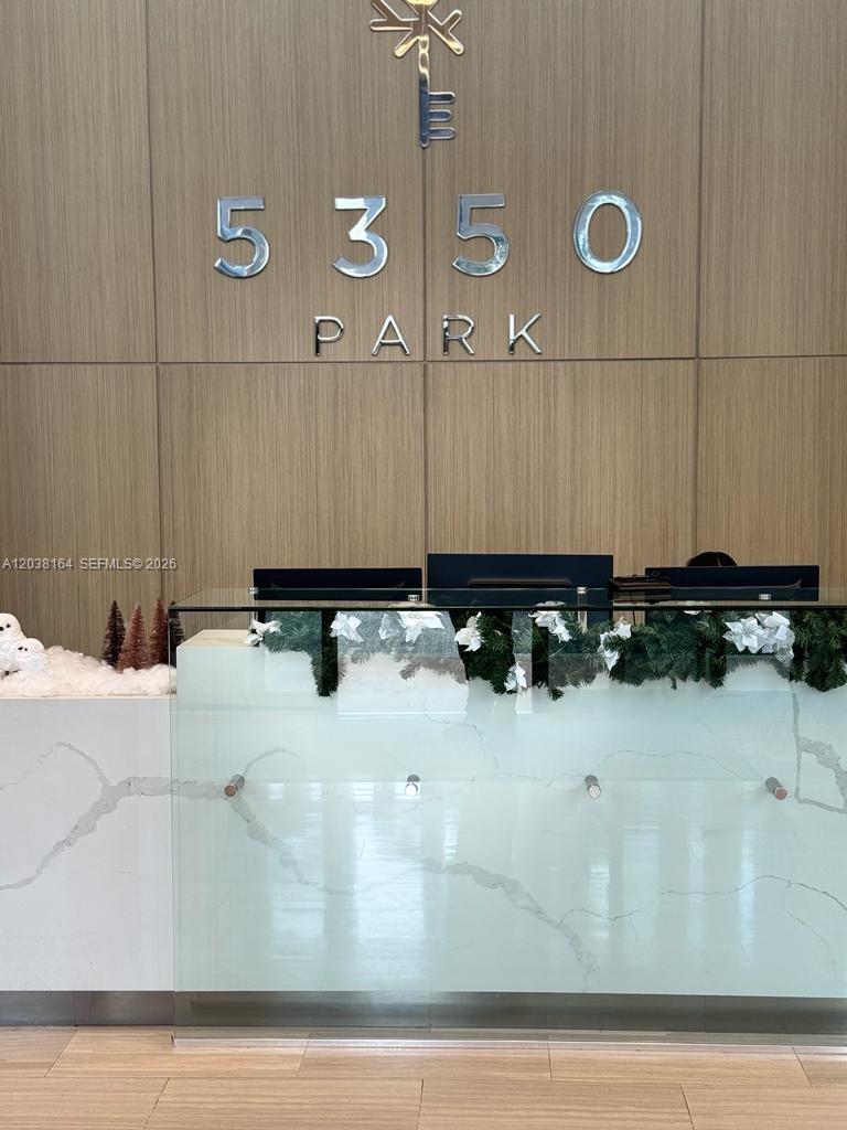 A reception desk with holiday decorations sits in front of a wall labeled 5350 Park — 5350 NW 84th Ave # 1018, Doral FL 33166, DORAL, FL