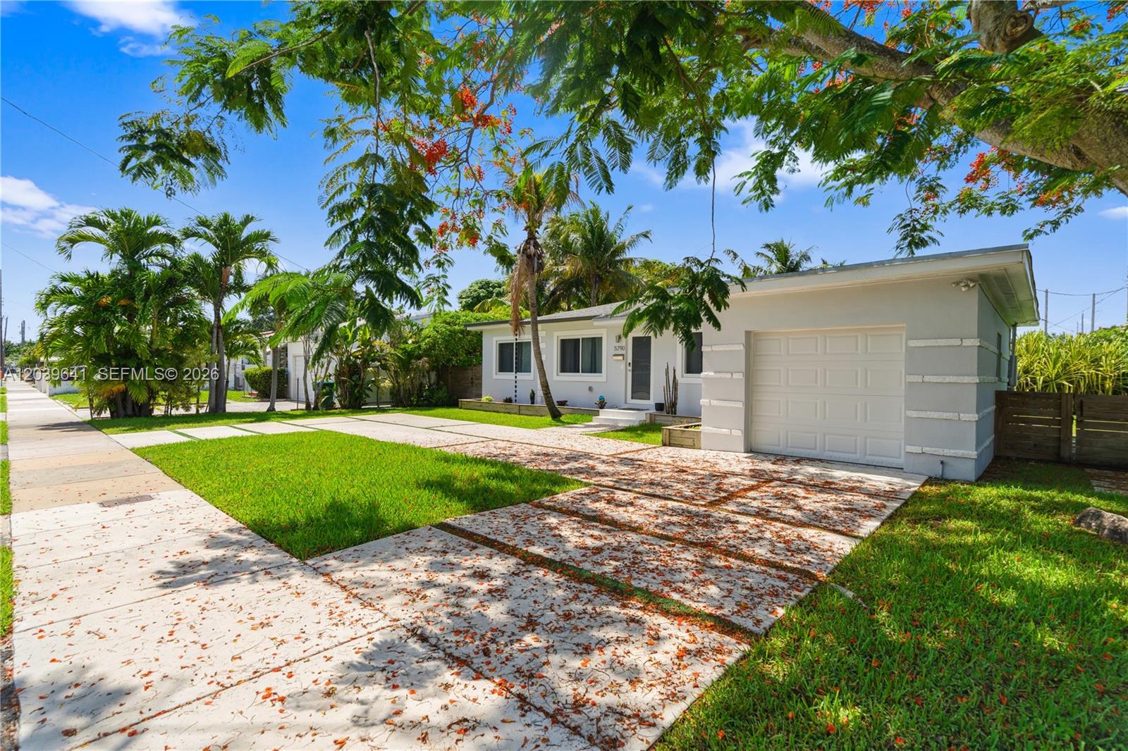 A single-story house with a white garage, a paved driveway, and palm trees in the yard — 5790 SW 3rd St, Miami FL 33144, MIAMI, FL