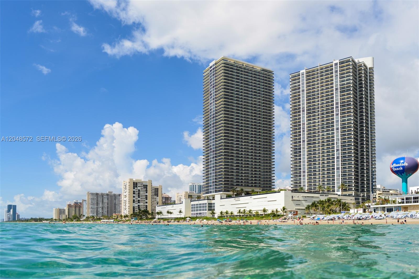 A beach view shows two tall residential towers and a Hallandale Beach water tower — 1800 S Ocean Dr # 2203, Hallandale Beach FL 33009, HALLANDALE BEACH, FL