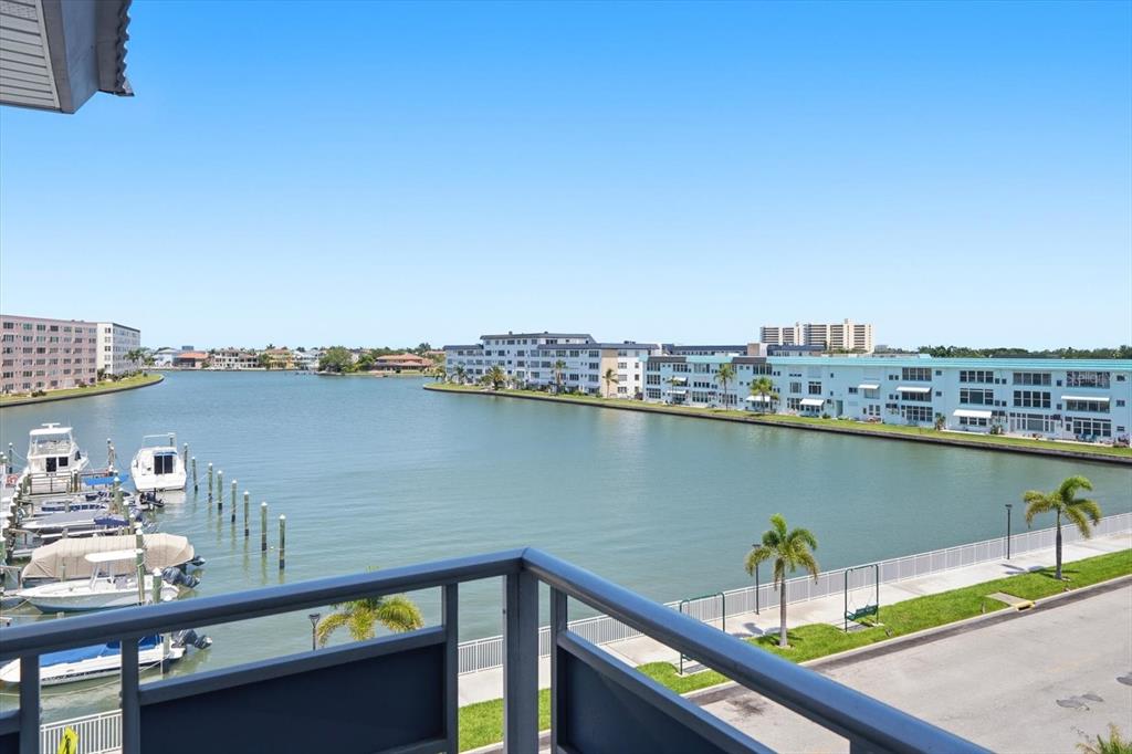 A balcony view overlooking a canal with docked boats and residential buildings — 3018 59TH STREET S UNIT 414, GULFPORT, FL