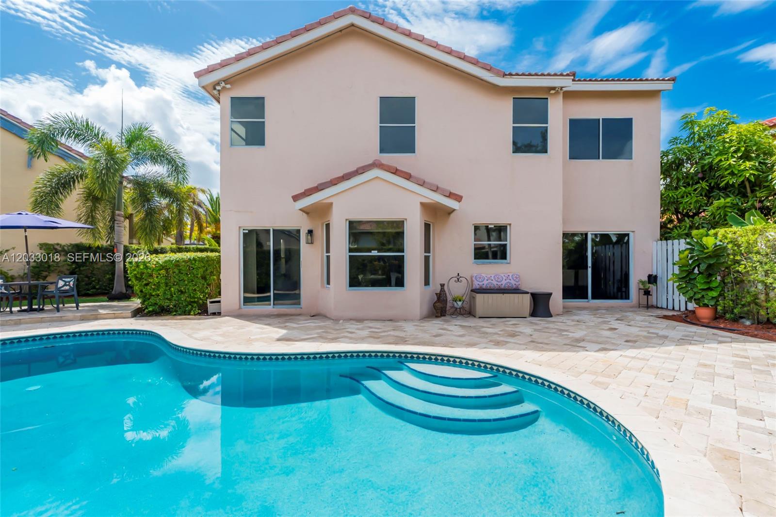 A two-story peach-colored house features a backyard swimming pool and a paved patio area — 18172 SW 3rd St, Pembroke Pines FL 33029, PEMBROKE PINES, FL