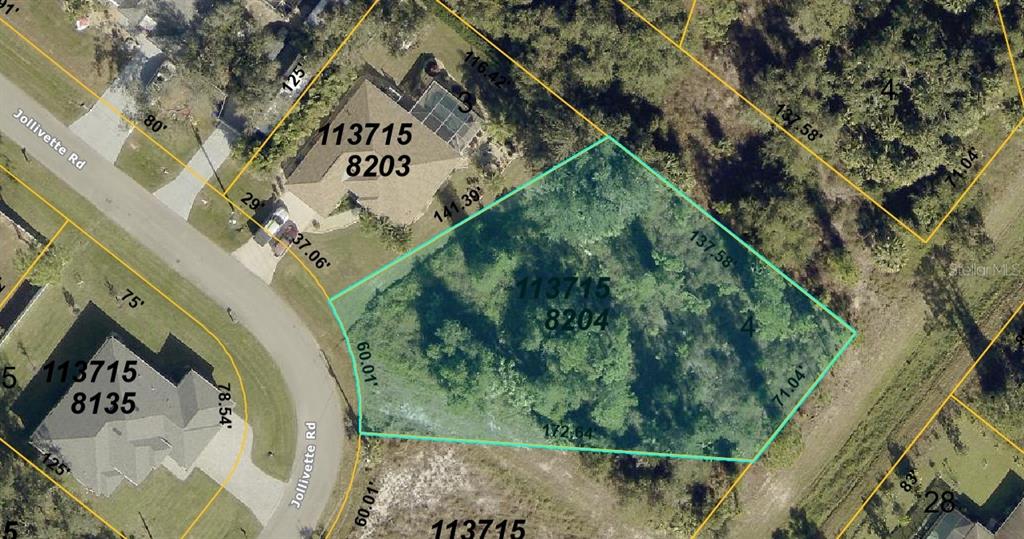 This is an aerial map showing a vacant, wooded residential lot outlined in light blue — JOLLIVETTE ROAD, NORTH PORT, FL