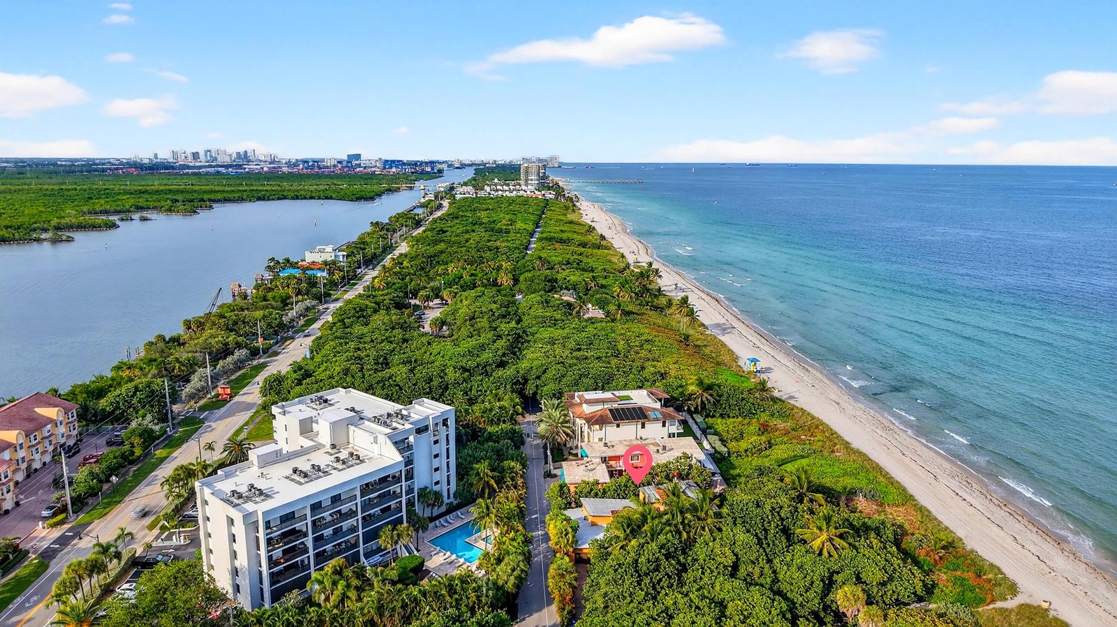 An aerial view shows a coastal property with a beach, dense trees, and residential buildings — 4200 N Surf Road, Hollywood FL 33019, HOLLYWOOD, FL