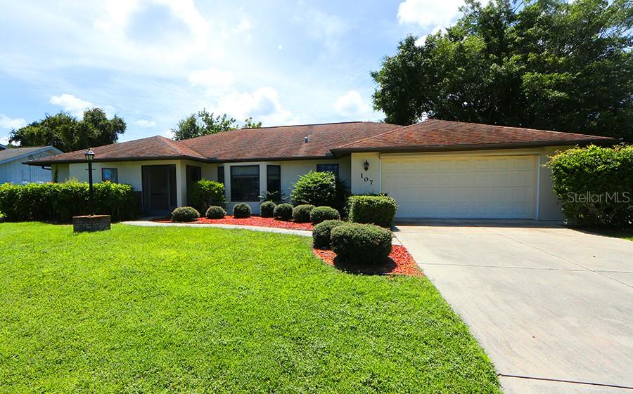 A single-story house with a beige exterior, a two-car garage, and a manicured front lawn — 147 HOURGLASS DRIVE, VENICE, FL