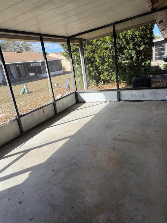 A screened-in porch with a concrete floor and metal framing overlooking a backyard — 500 E ROSEWOOD LANE UNIT 154, TAVARES, FL
