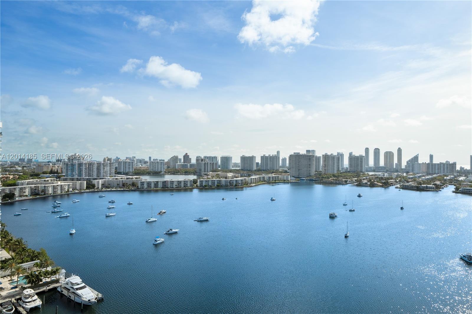 An elevated view of a bay filled with boats, surrounded by high-rise apartment buildings — 17111 Biscayne Blvd # 2107, North Miami Beach FL 33160, NORTH MIAMI BEACH, FL