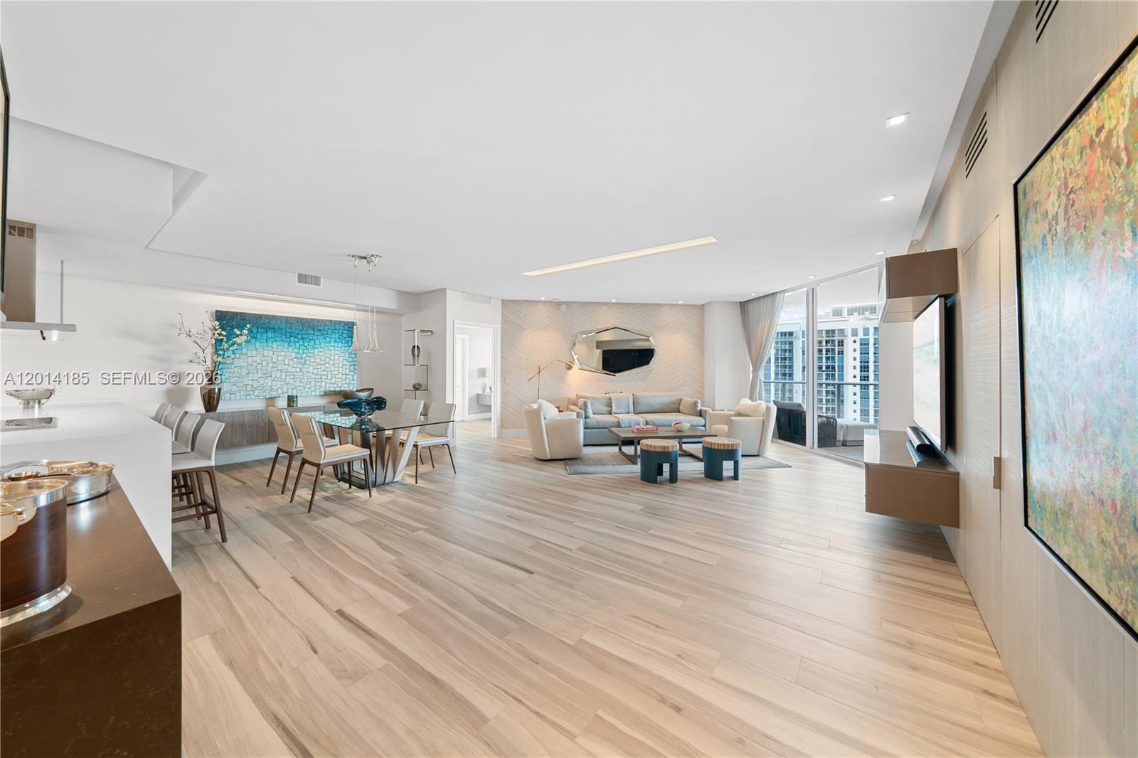 A modern open-concept living and dining area features light wood flooring and floor-to-ceiling windows — 17111 Biscayne Blvd # 2107, North Miami Beach FL 33160, NORTH MIAMI BEACH, FL