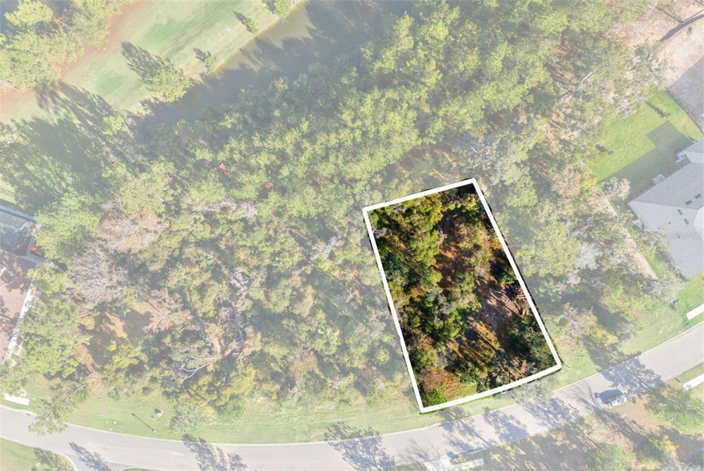 An aerial view shows a rectangular, wooded vacant lot situated along a curved residential street — 6633 SUMMIT VIEW DRIVE, BROOKSVILLE, FL
