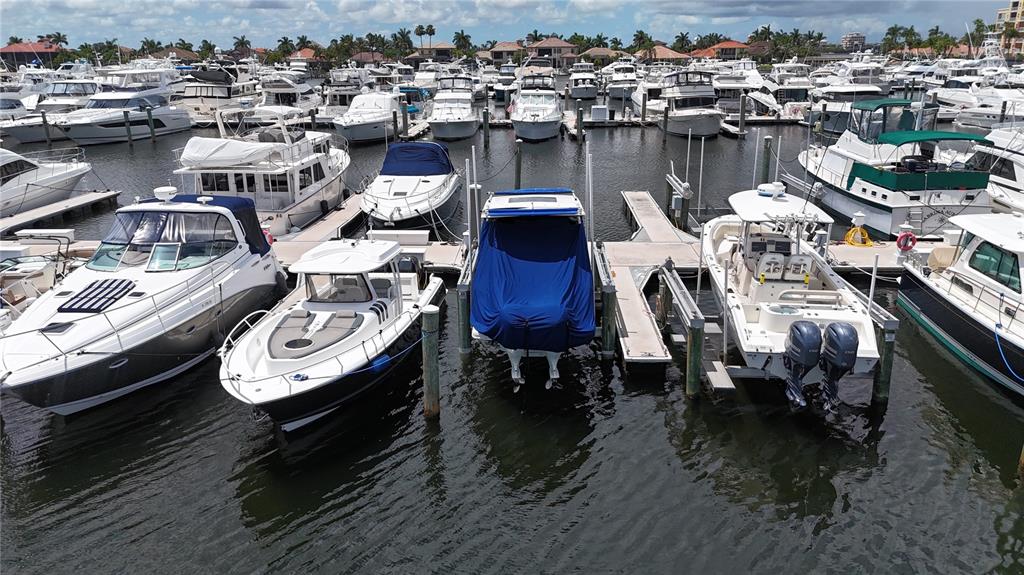 A marina filled with numerous motorboats and yachts docked in calm water under a cloudy sky — 102 RIVIERA DUNES WAY UNIT N-21, PALMETTO, FL