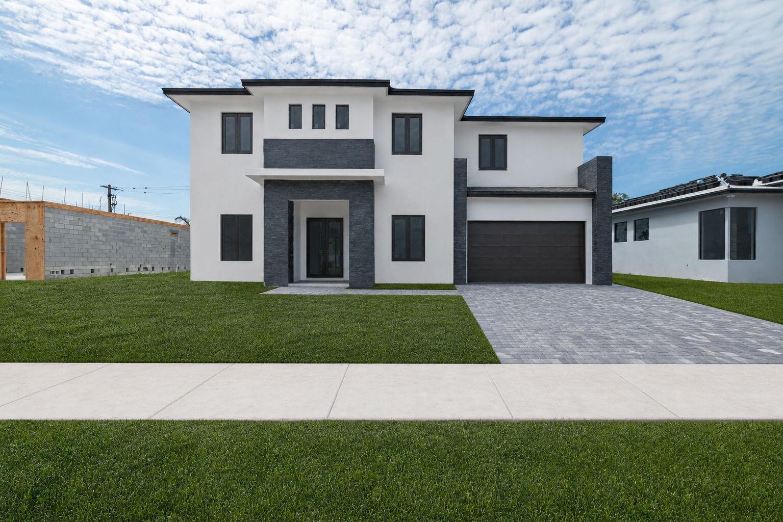 A two-story modern house with white stucco, dark stone accents, and a paved driveway — 13044 Davie Oaks Drive, Davie FL 33325, DAVIE, FL