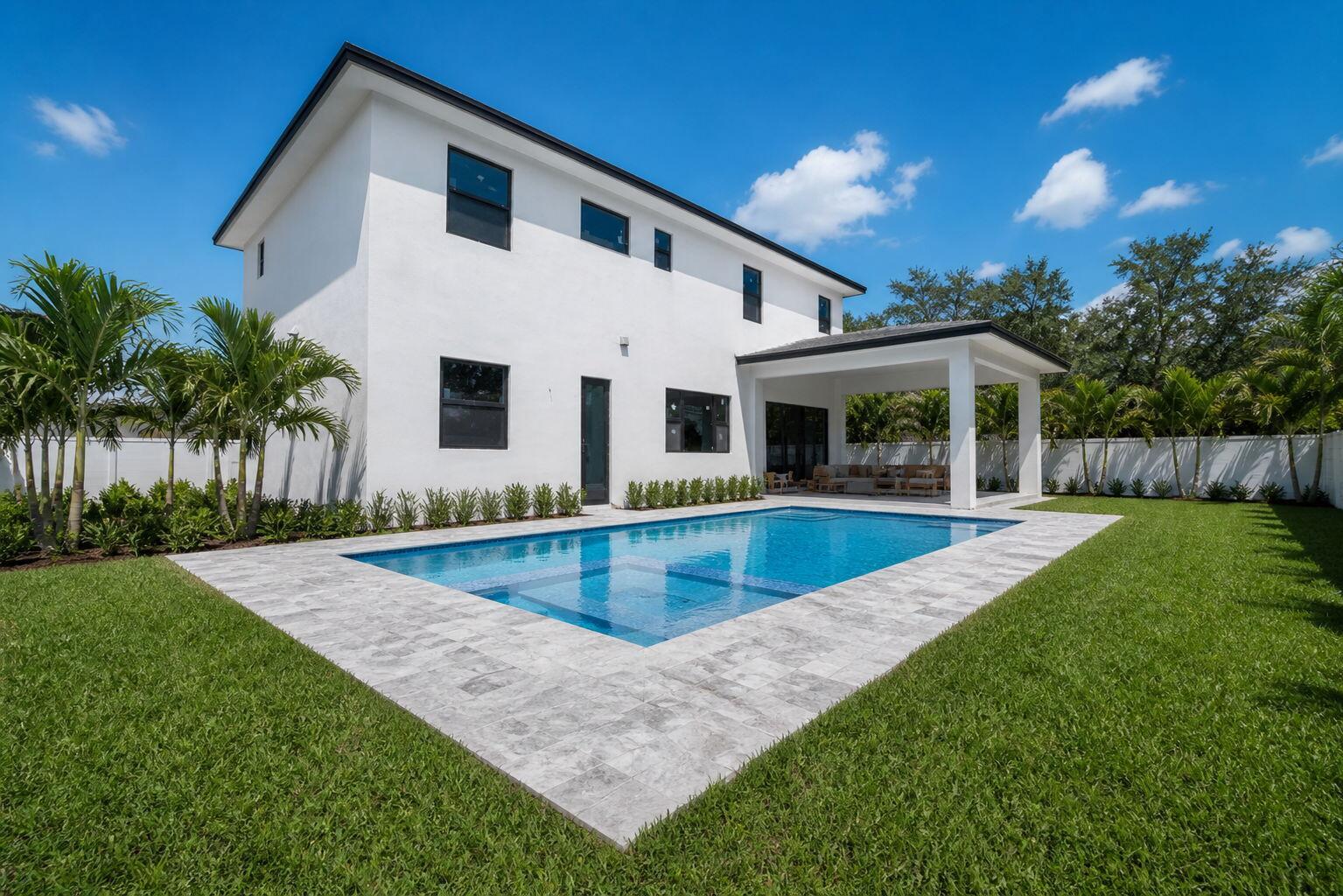 A white two-story house features a backyard swimming pool, stone patio, and covered lanai — 13044 Davie Oaks Drive, Davie FL 33325, DAVIE, FL