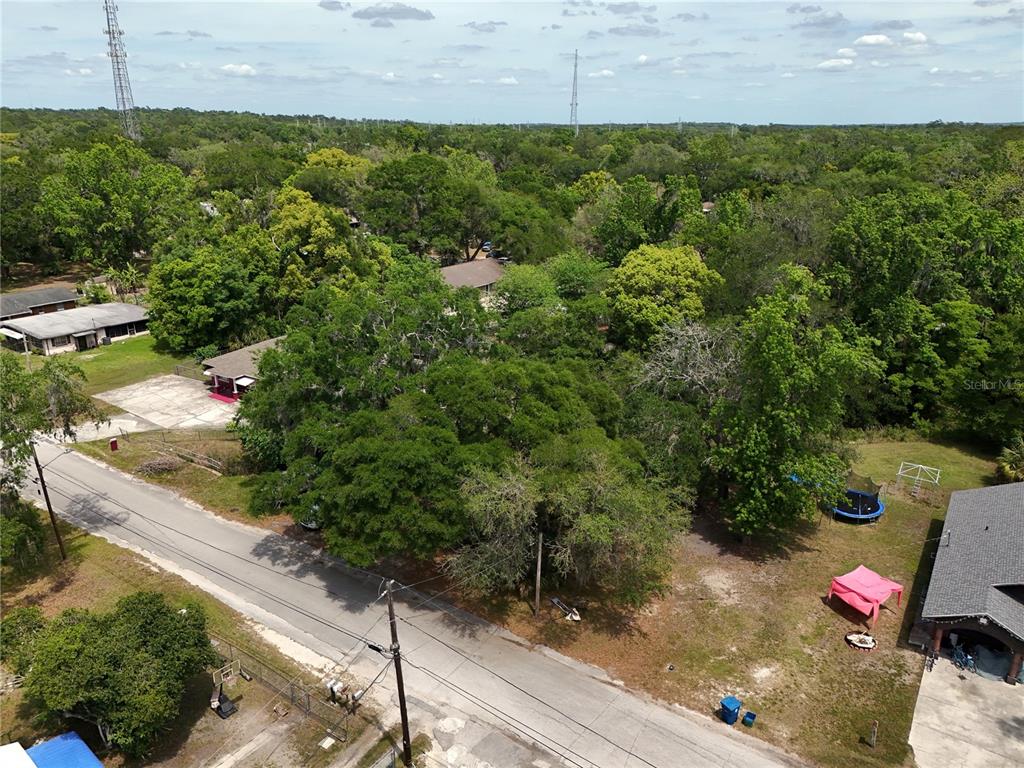 An aerial view shows a residential street with houses, large trees, and a grassy yard — JOSEPHINE STREET, BROOKSVILLE, FL