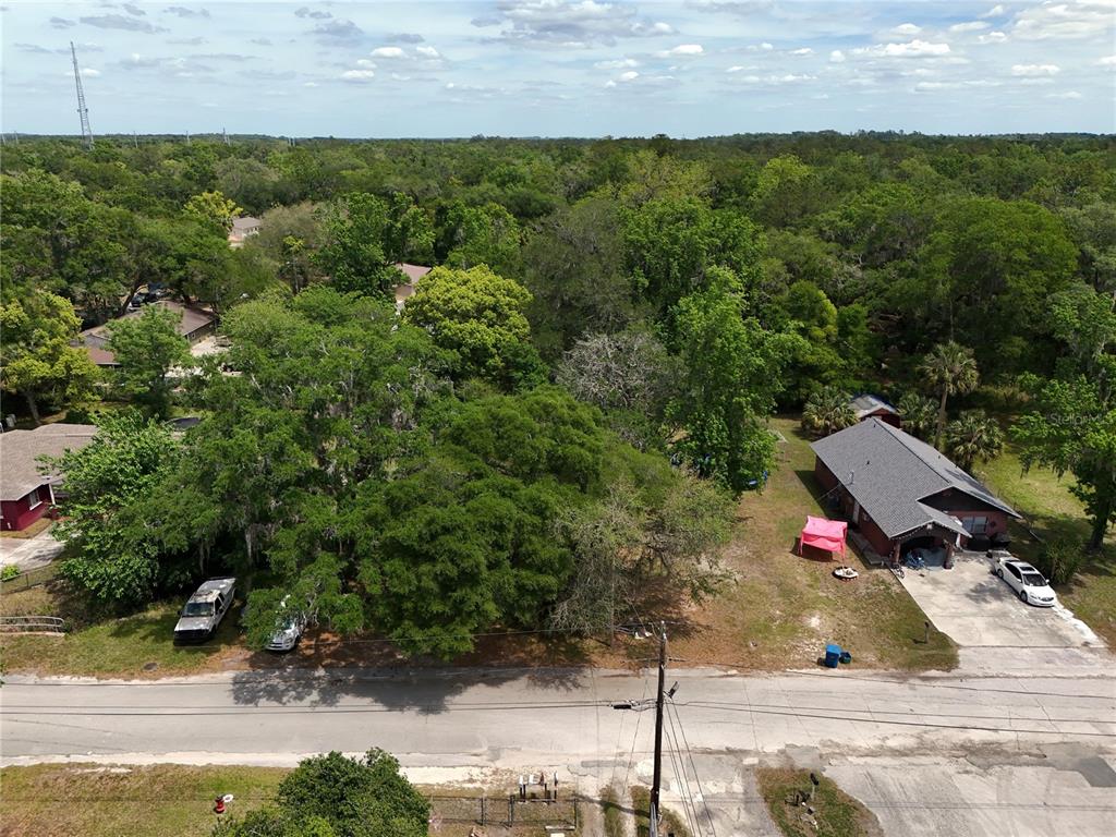 An aerial view shows a residential property with a house, driveway, and surrounding trees — JOSEPHINE STREET, BROOKSVILLE, FL