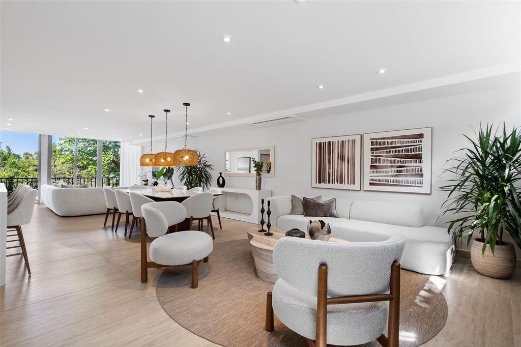 A bright, open-plan living and dining area features modern furniture, neutral tones, and large windows — 2613 VILLAS DORADO ESTATES, DORADO, PR