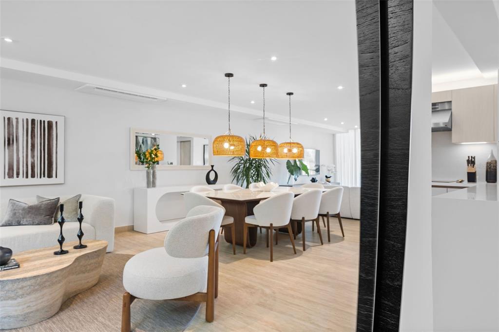 A modern open-concept living and dining area features light wood flooring and woven pendant lights — 2613 VILLAS DORADO ESTATES, DORADO, PR
