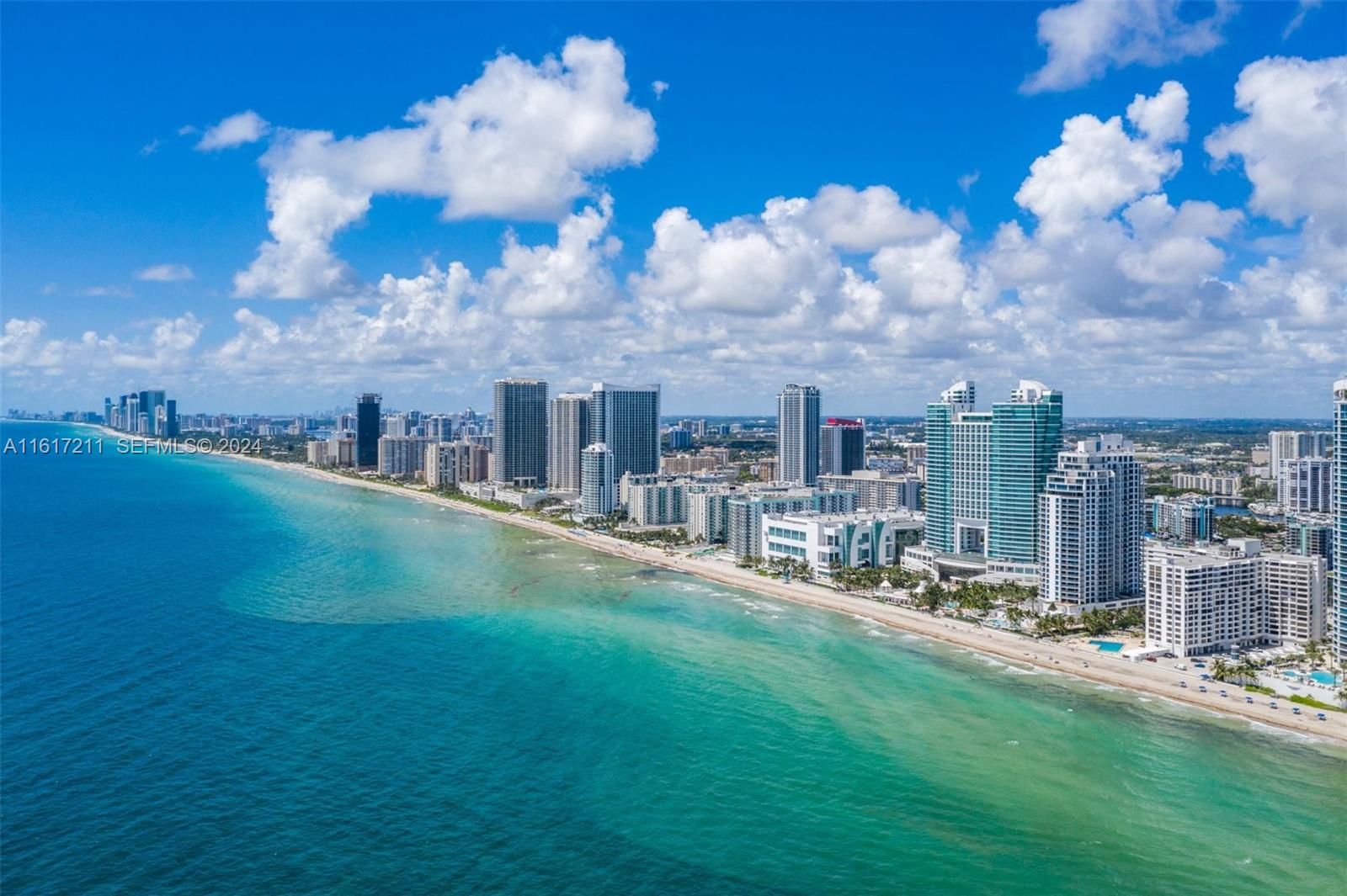 An aerial view of a sandy beach lined with high-rise buildings along the ocean — 1980 S Ocean Dr # 2C, Hallandale Beach FL 33009, HALLANDALE BEACH, FL