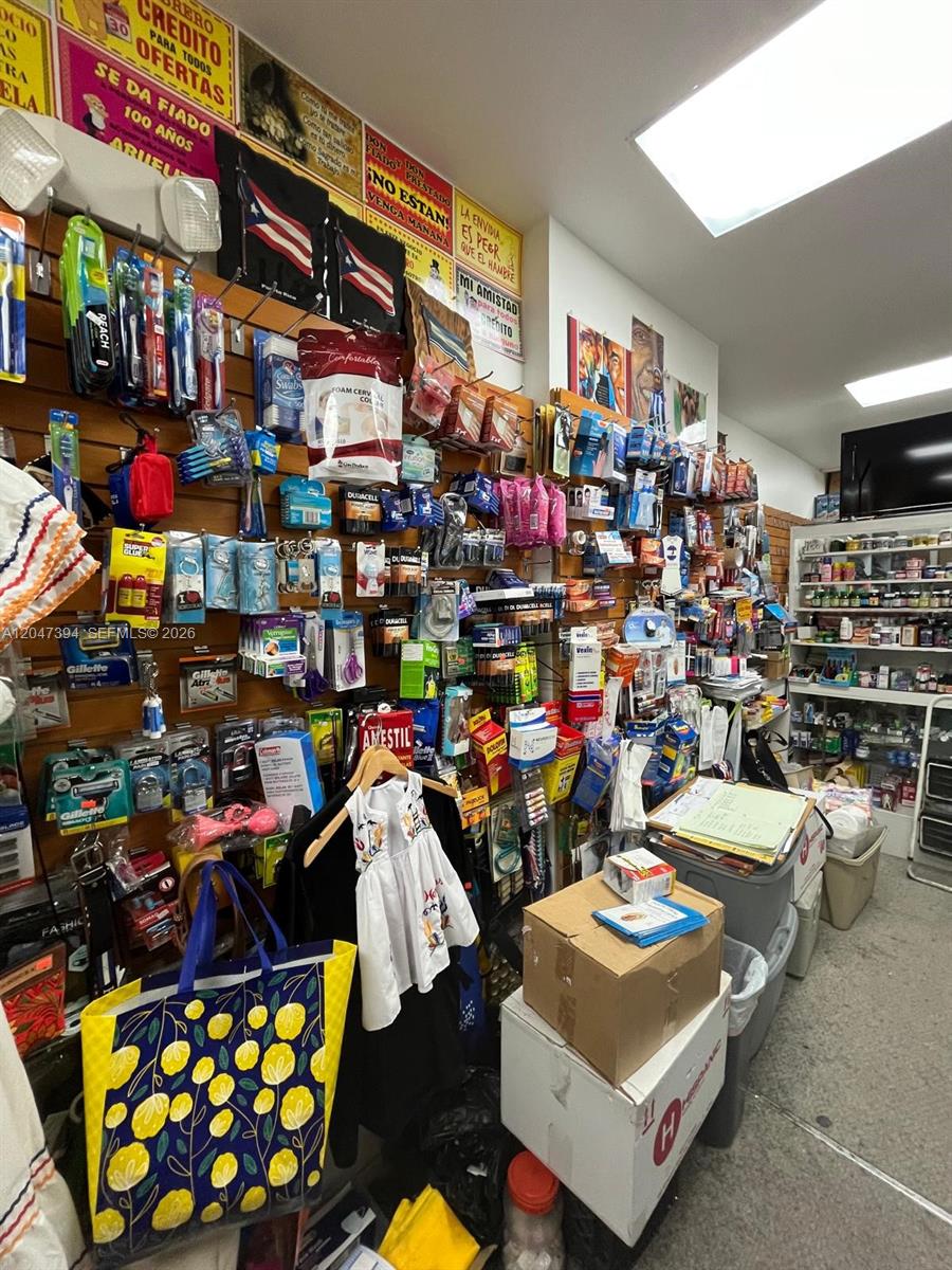 A retail store interior features walls lined with various packaged goods and merchandise on display — 222 NE 25th St, Miami FL 33137, MIAMI, FL