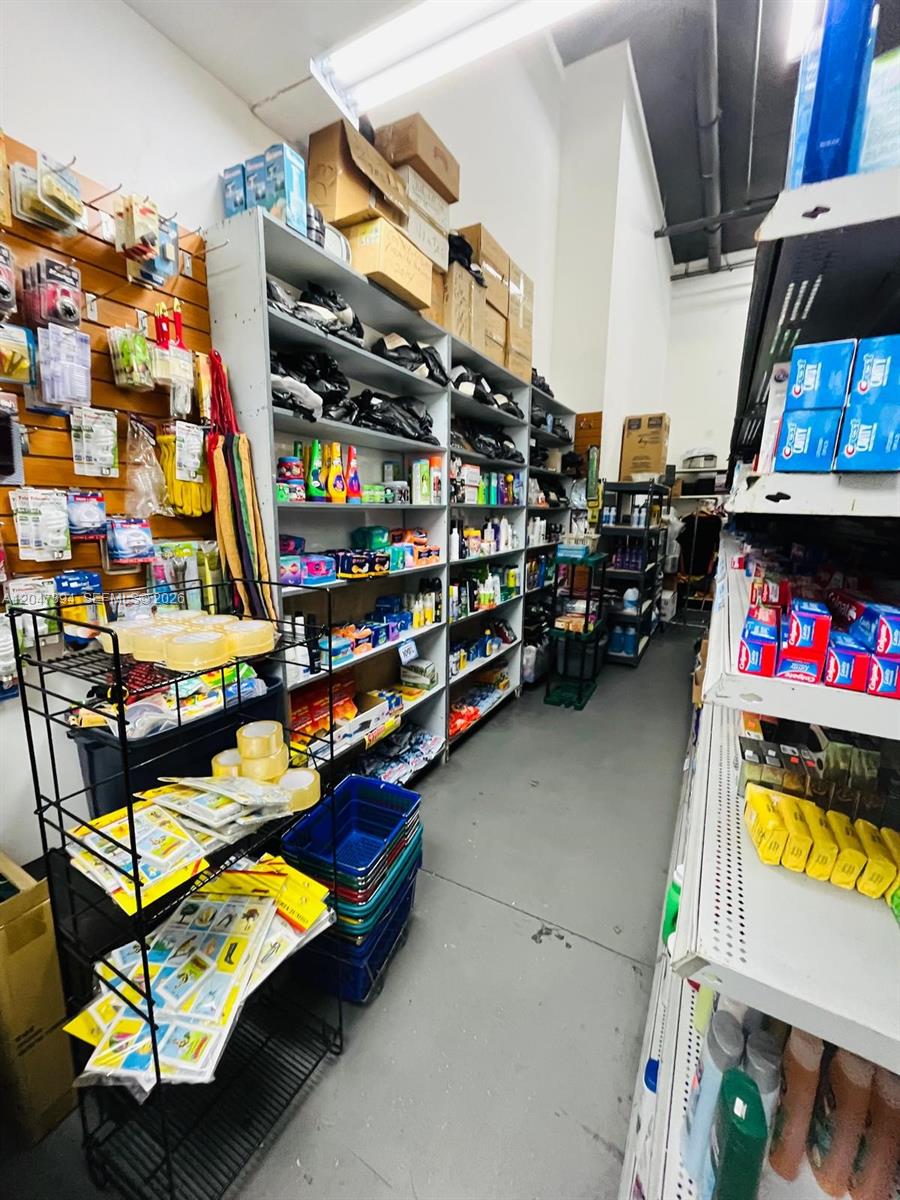 A retail storage room features metal shelving units stocked with various household and cleaning supplies — 222 NE 25th St, Miami FL 33137, MIAMI, FL