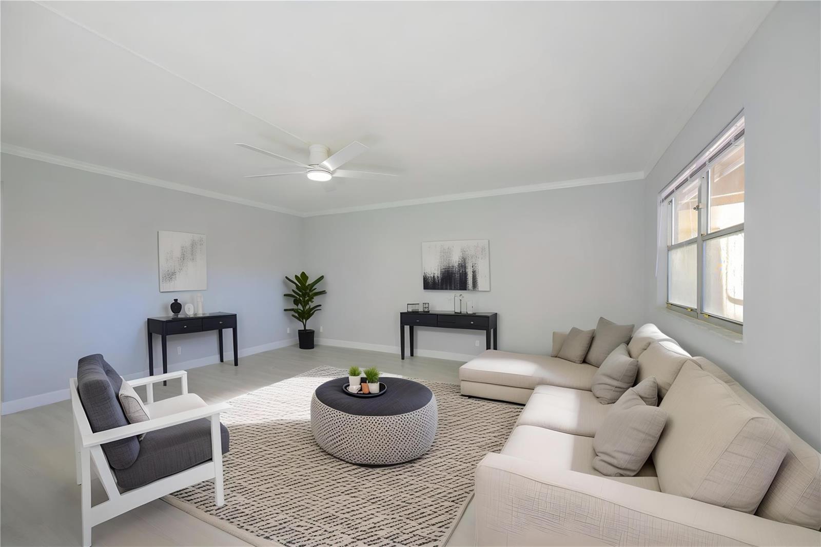 A living room features a beige sectional sofa, a grey armchair, and a round ottoman — 633 Brittany # 633, Delray Beach FL 33446, DELRAY BEACH, FL