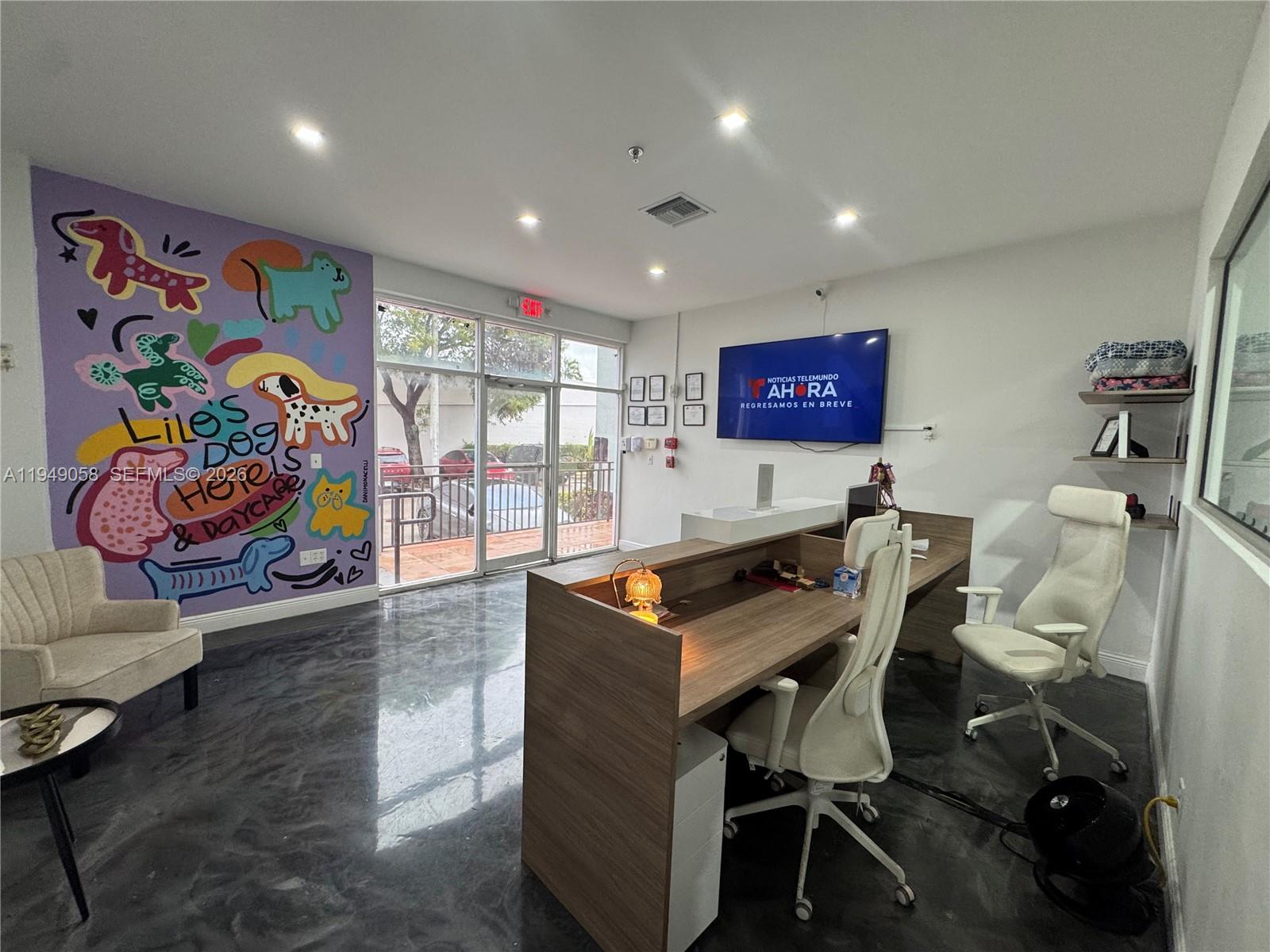 A commercial office space features a colorful dog-themed mural, a reception desk, and polished floors — 8347 NW 36th St, Doral FL 33166, DORAL, FL