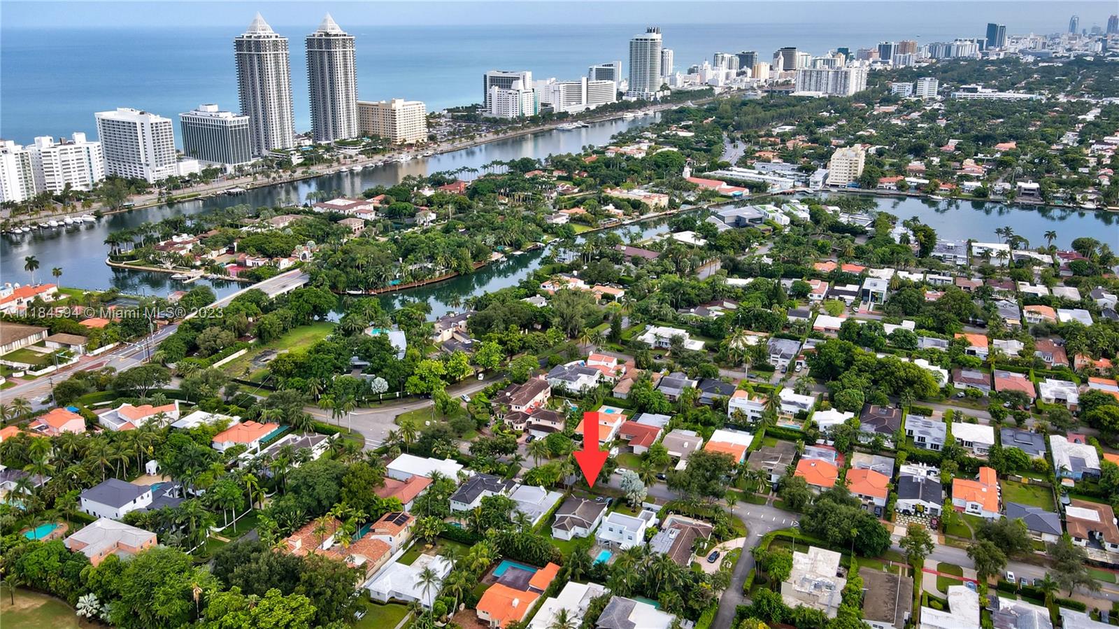 An aerial view shows a residential neighborhood with a red arrow pointing to a house — 535 W 51st St, Miami Beach FL 33140, MIAMI BEACH, FL