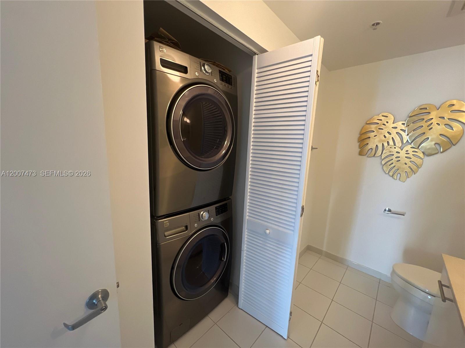 A stacked washer and dryer unit is located in a closet within a bathroom — 3470 E Coast Ave # H0501, Miami FL 33137, MIAMI, FL