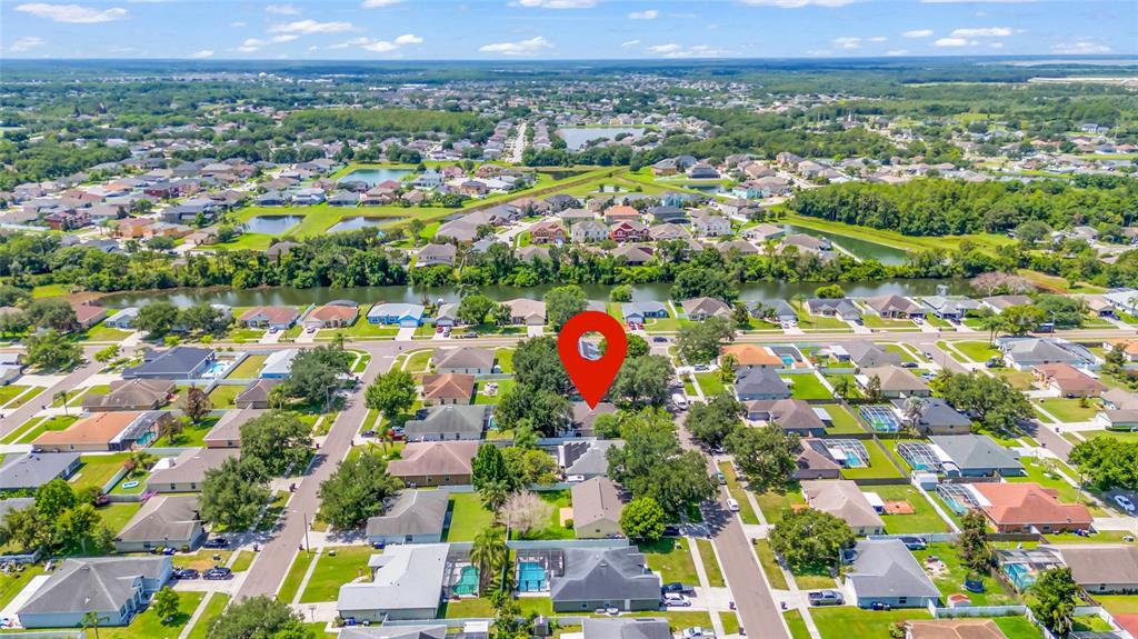 An aerial view shows a suburban neighborhood with a red location pin over a house — 4211 FLOATING ORCHID COURT, ST CLOUD, FL