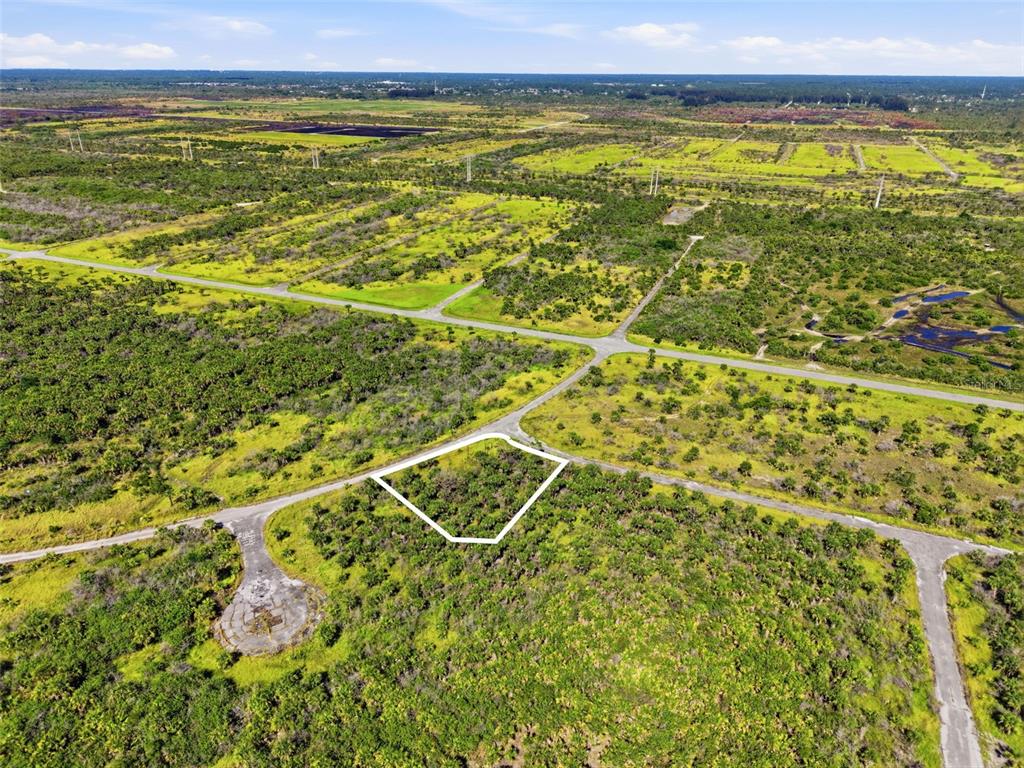 An aerial view shows a vacant, brush-covered lot outlined in white within a rural subdivision — NO ADDRESS, PALM BAY, FL