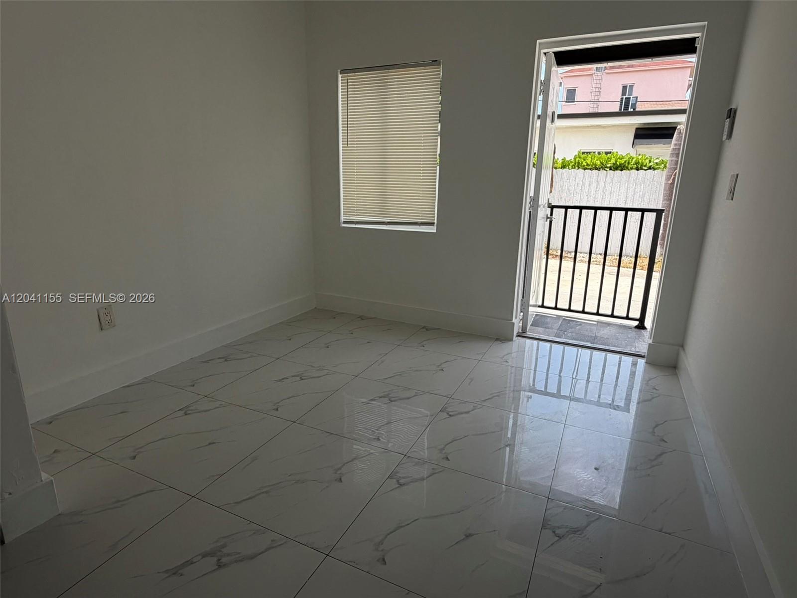 A room with white marble-patterned tile floors, a window with blinds, and a glass door — 111 SW 11 Ave # 5, Miami FL 33130, MIAMI, FL