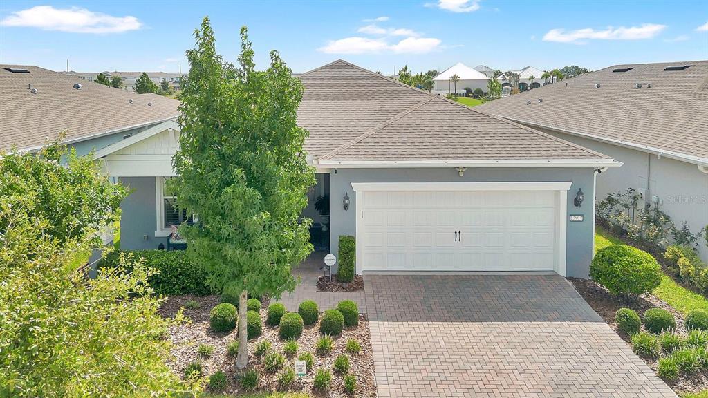 A single-story house with a gray exterior, a two-car garage, and a paved driveway — 13917 DESTIN BEACH LANE, ORLANDO, FL