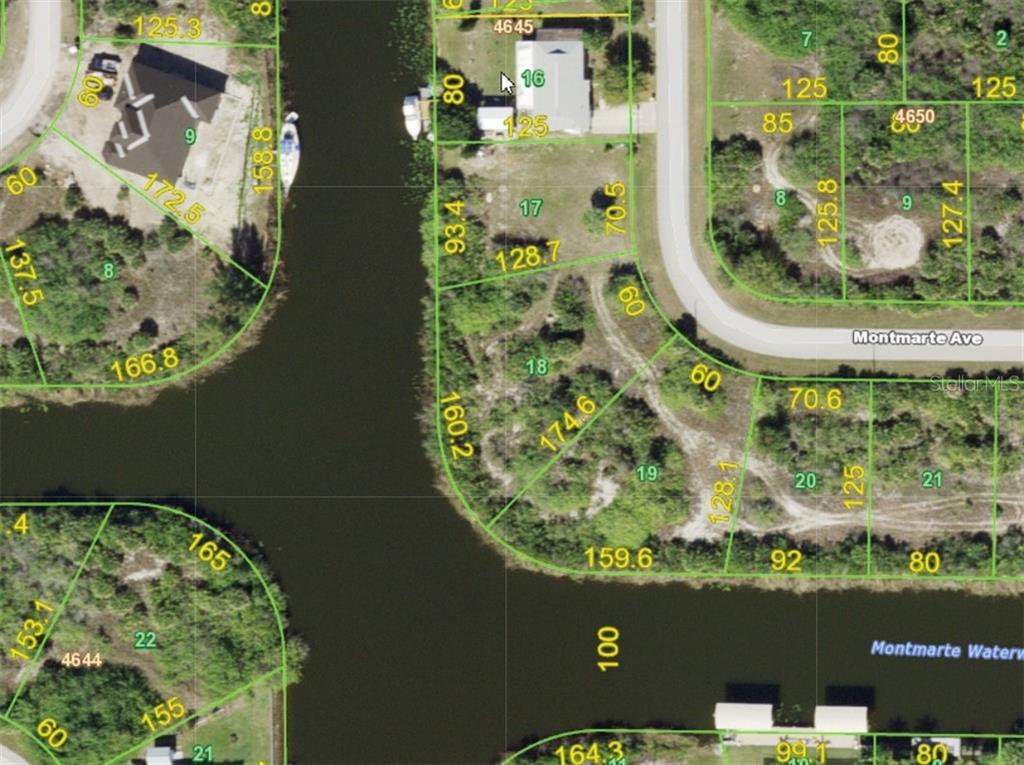 This is an aerial map showing residential lots and a canal in a suburban area — 14275 MONTMARTE AVENUE, PORT CHARLOTTE, FL