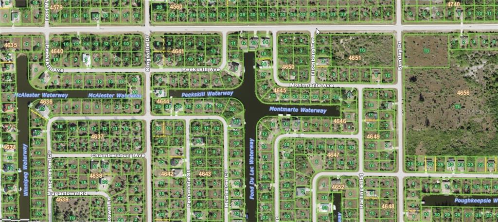 This is an aerial map showing residential lots, streets, and waterways in a suburban neighborhood — 14275 MONTMARTE AVENUE, PORT CHARLOTTE, FL