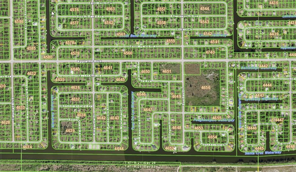 This is a satellite map view of a residential neighborhood with streets and waterways — 14275 MONTMARTE AVENUE, PORT CHARLOTTE, FL