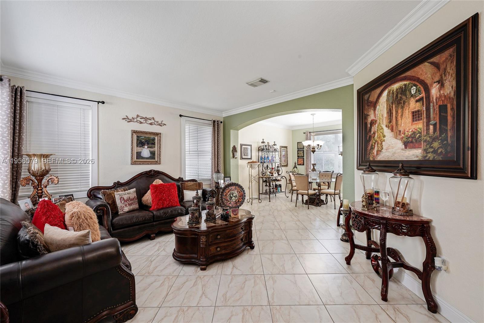 A living room with leather furniture, a coffee table, and an adjacent dining area — 2250 SW 155th Ave, Miami FL 33185, MIAMI, FL