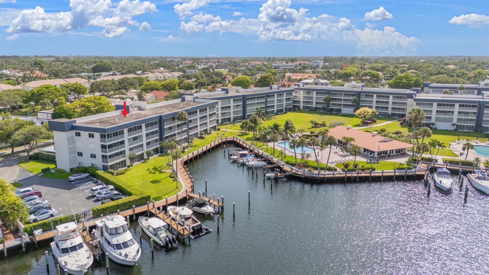 An aerial view shows a multi-story apartment building with a boat dock and swimming pool — 951 Spanish Circle # 346, Delray Beach FL 33483, DELRAY BEACH, FL